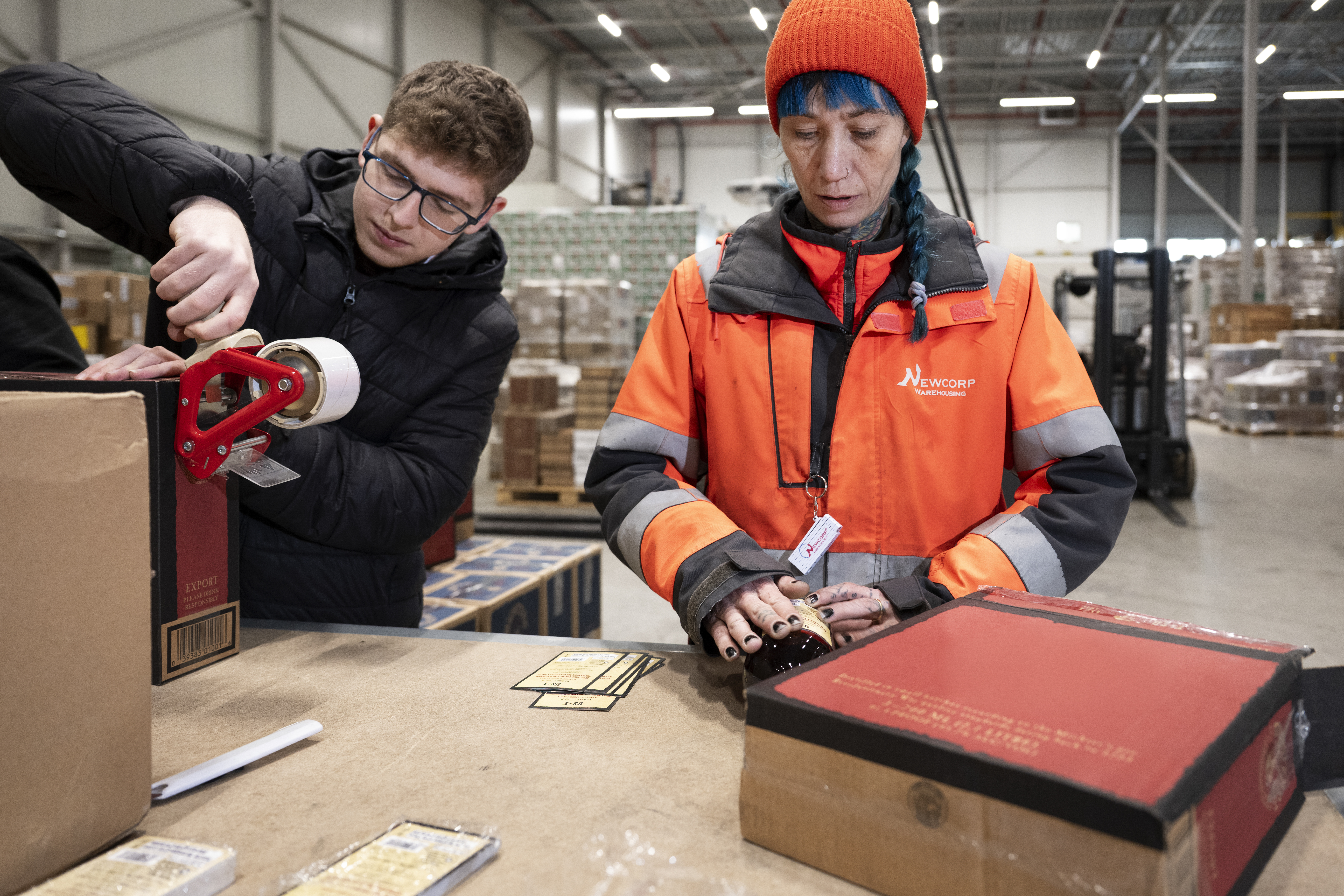 Employees work with products for the food & beverage category.